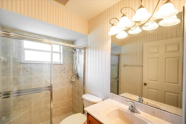 bathroom featuring vanity, toilet, a textured ceiling, a notable chandelier, and a shower with shower door