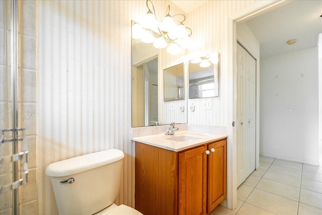 bathroom featuring a chandelier, vanity, tile patterned flooring, and toilet