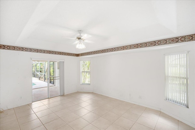 tiled spare room with ceiling fan