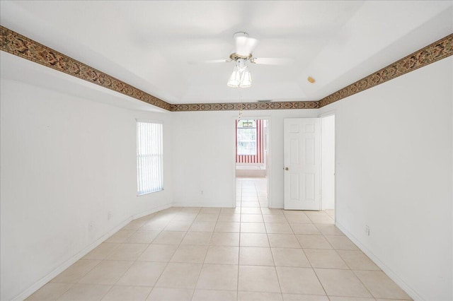 unfurnished room with light tile patterned floors and ceiling fan