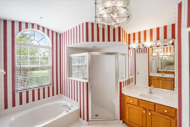 bathroom with vanity, a textured ceiling, and shower with separate bathtub