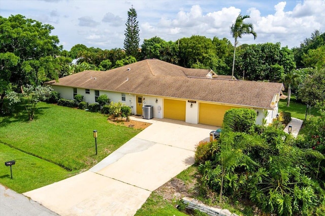 ranch-style house featuring central AC, a front lawn, and a garage