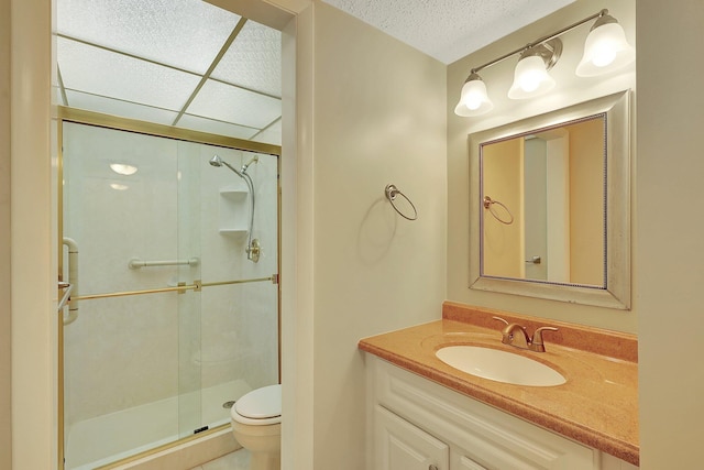 bathroom with vanity, an enclosed shower, and toilet