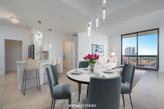 dining space featuring light tile patterned flooring and sink