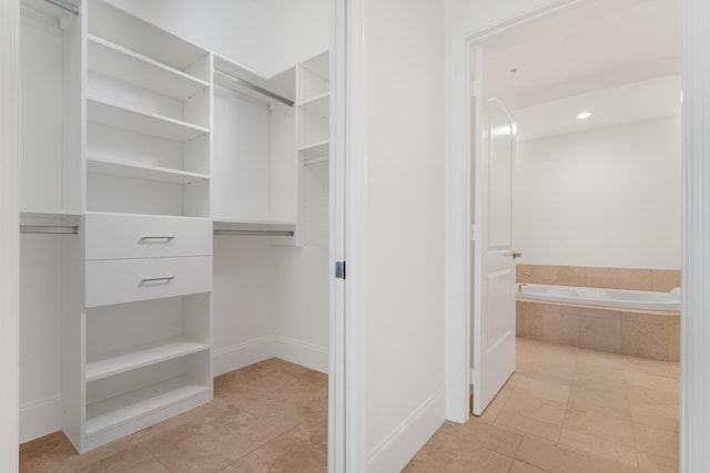 spacious closet with light tile patterned floors