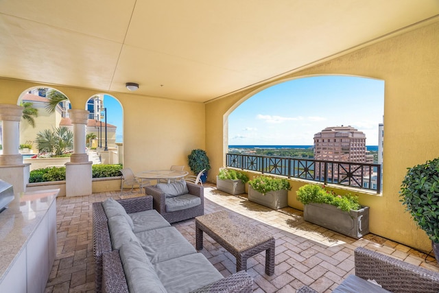 view of patio / terrace with outdoor lounge area and a water view