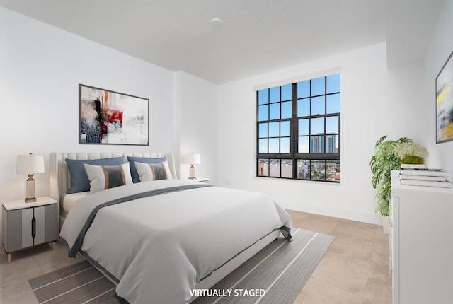 tiled bedroom featuring a textured ceiling