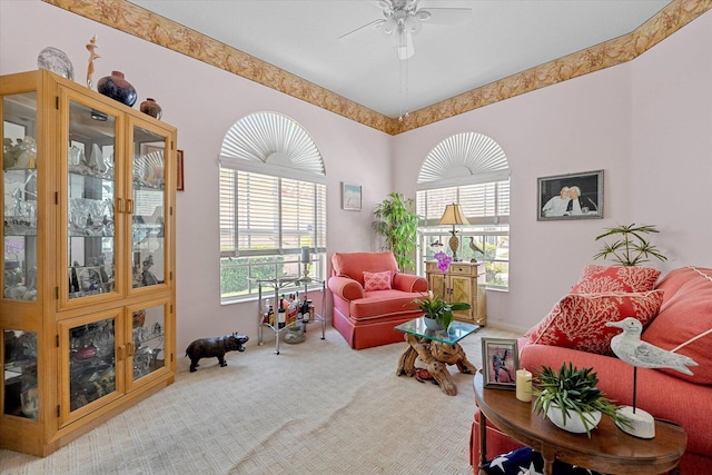 living area featuring carpet flooring and ceiling fan