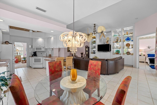 tiled dining space with an inviting chandelier