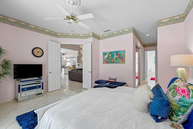 tiled bedroom featuring connected bathroom, multiple windows, and ceiling fan