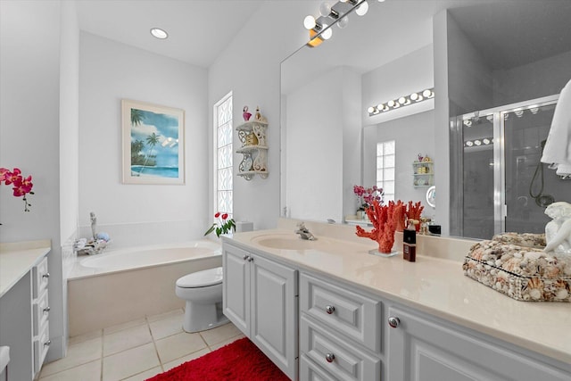 full bathroom featuring toilet, vanity, tile patterned floors, and a wealth of natural light