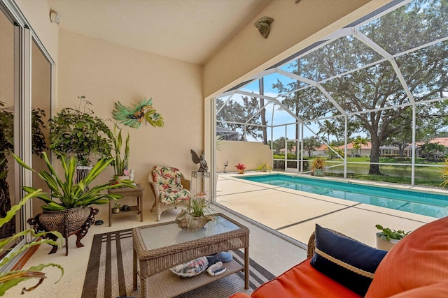 view of swimming pool featuring glass enclosure and a patio