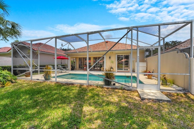 view of swimming pool with a lawn, a lanai, and a patio