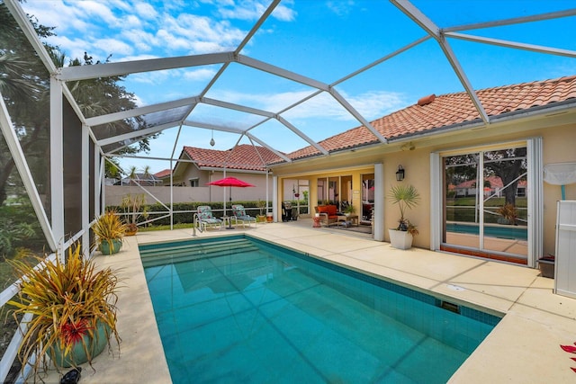 view of pool featuring a patio and glass enclosure