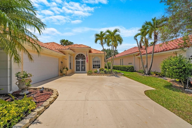 mediterranean / spanish-style home with a garage