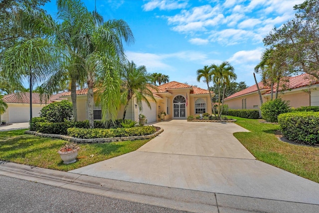 mediterranean / spanish home with a front lawn