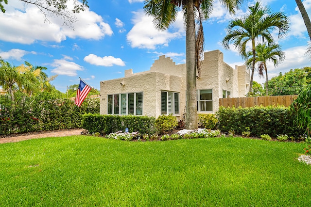 back of property featuring a yard