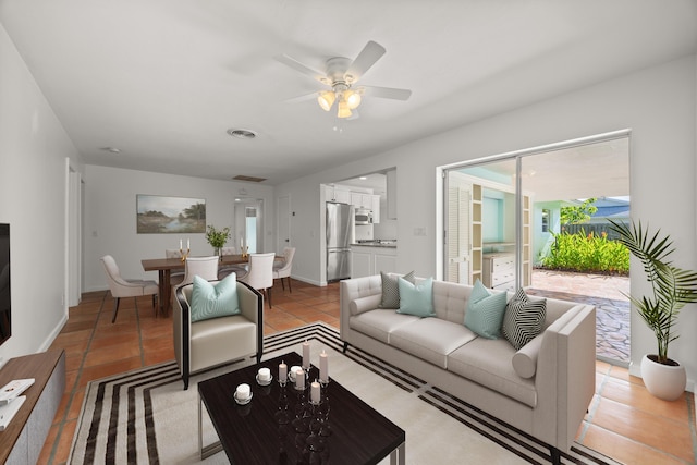 living room featuring ceiling fan and light tile patterned flooring