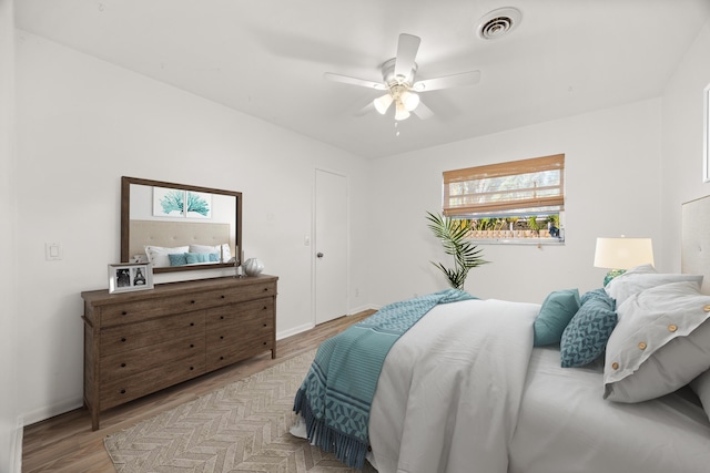 bedroom with light hardwood / wood-style floors and ceiling fan