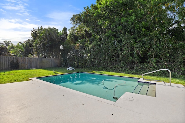 view of pool featuring a lawn and a patio area