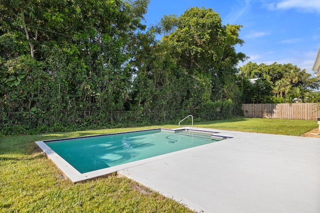 view of swimming pool with a patio area and a yard