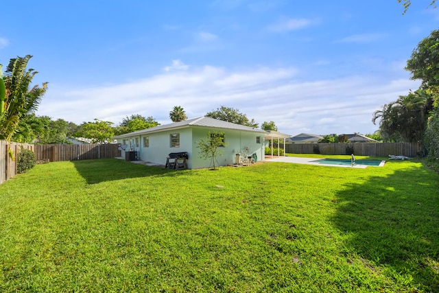 view of yard with a fenced in pool