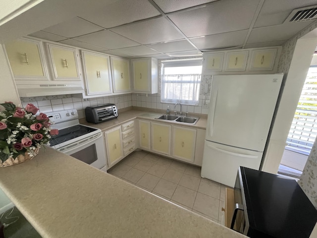 kitchen with sink, white cabinetry, a paneled ceiling, white appliances, and decorative backsplash