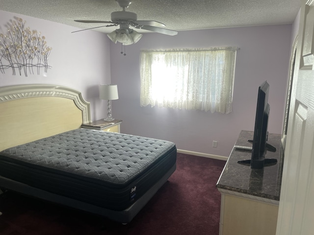 carpeted bedroom with ceiling fan and a textured ceiling