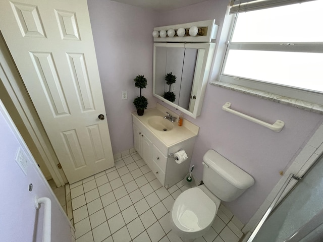 bathroom featuring tile patterned flooring, vanity, and toilet