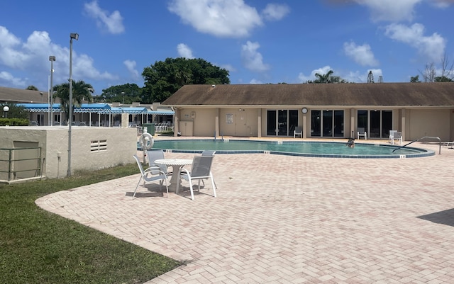 view of pool featuring a patio area