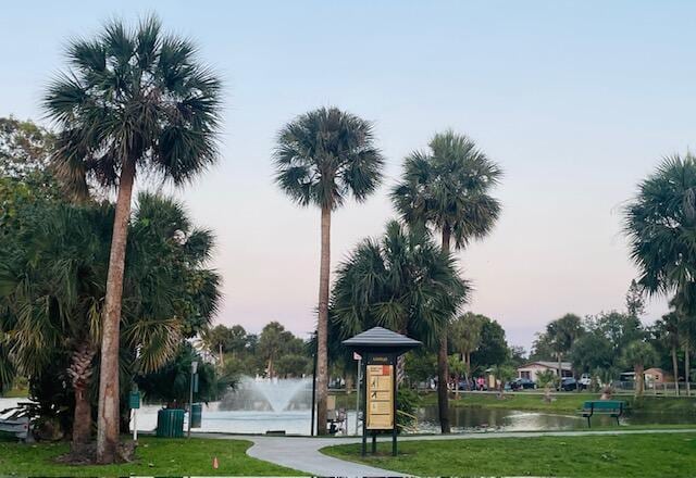 surrounding community with a yard and a water view