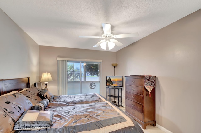 bedroom featuring a textured ceiling and ceiling fan