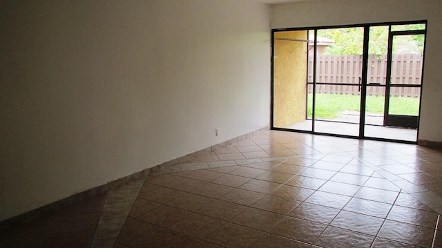 spare room with tile patterned flooring