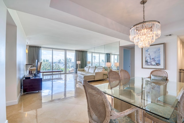 dining area with expansive windows and a notable chandelier