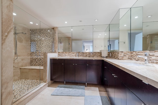 bathroom with backsplash, tile patterned floors, vanity, and an enclosed shower