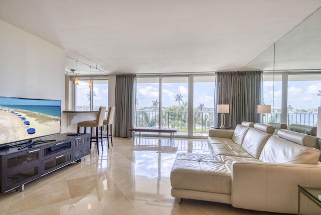 living room featuring a water view and a wall of windows