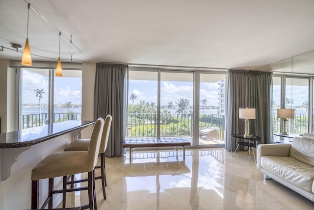 interior space with expansive windows and a water view