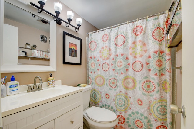 bathroom with toilet and large vanity