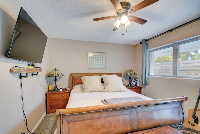 bedroom with ceiling fan, a textured ceiling, and carpet flooring