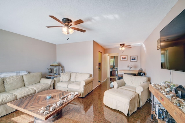 living room with a textured ceiling and ceiling fan