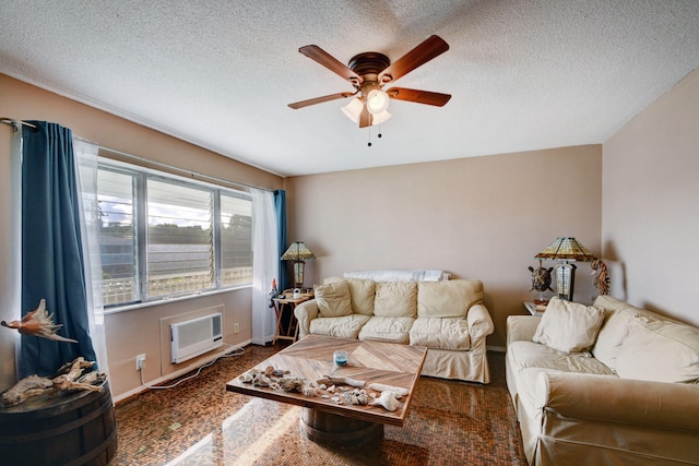 living room featuring ceiling fan, a textured ceiling, dark colored carpet, and a wall mounted air conditioner