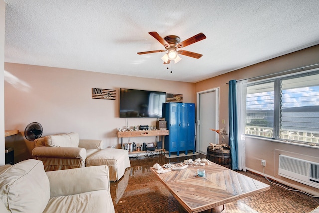 living room with a textured ceiling, ceiling fan, and hardwood / wood-style floors