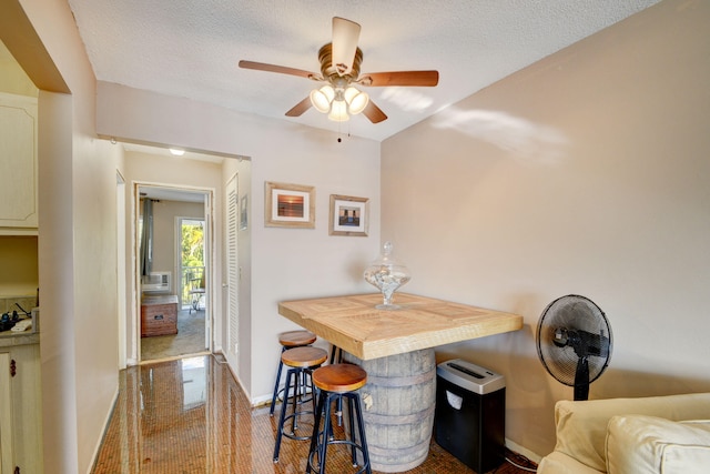 dining area featuring a textured ceiling and ceiling fan