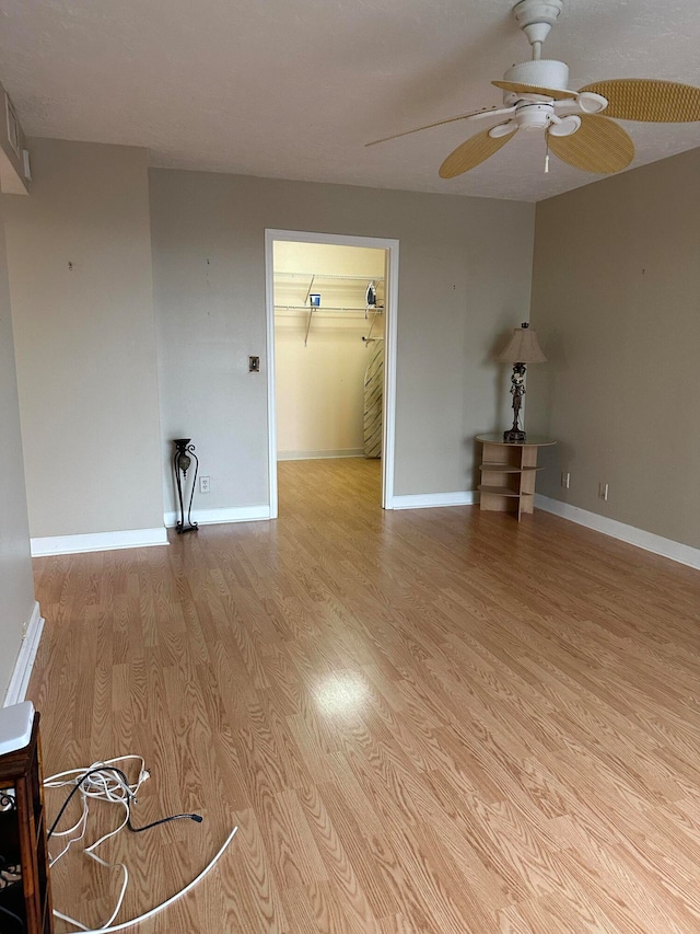 empty room featuring ceiling fan and hardwood / wood-style flooring