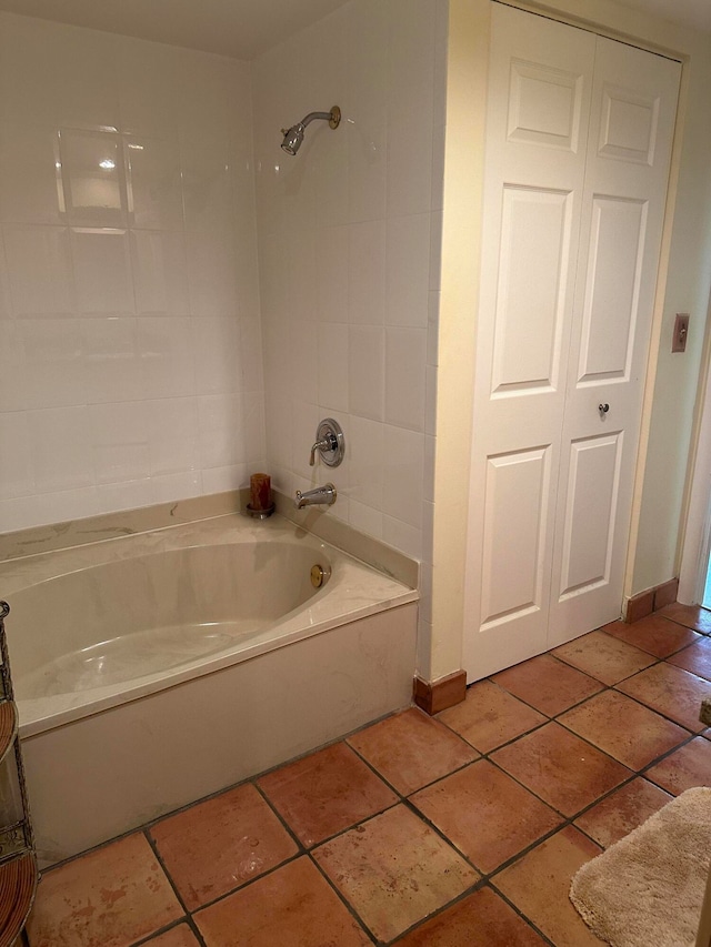 bathroom with tiled shower / bath combo and tile floors