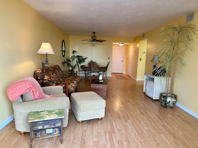 living room with ceiling fan and hardwood / wood-style floors