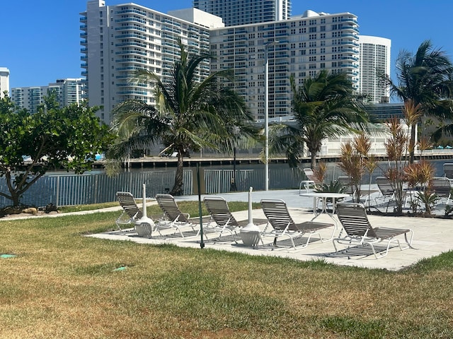 view of home's community featuring a patio area and a yard