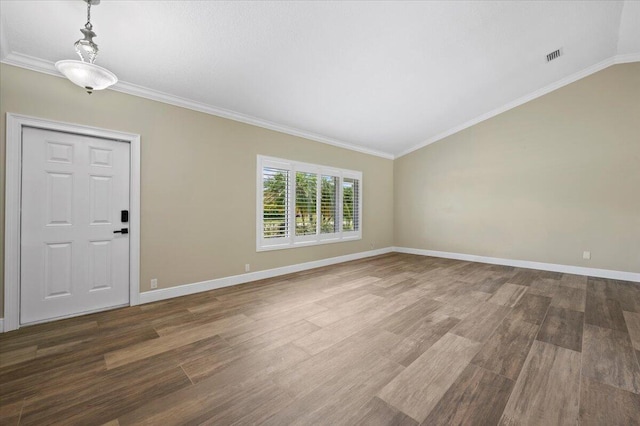 foyer with ornamental molding, dark hardwood / wood-style floors, and lofted ceiling