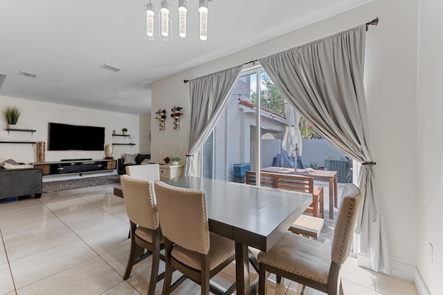 dining area with light tile patterned floors and visible vents