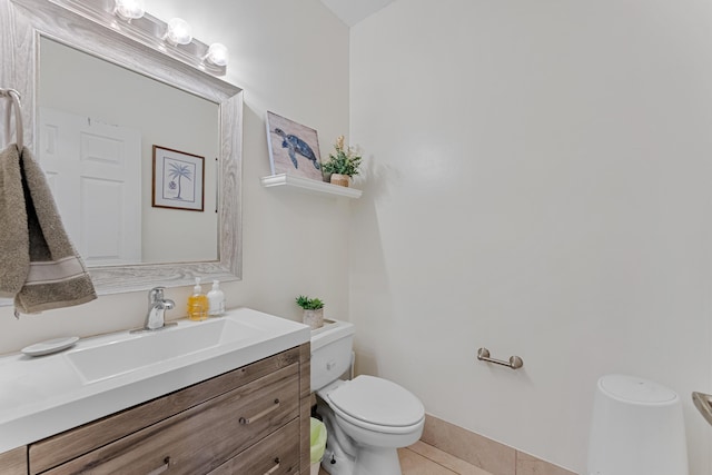 bathroom with tile patterned flooring, vanity, and toilet